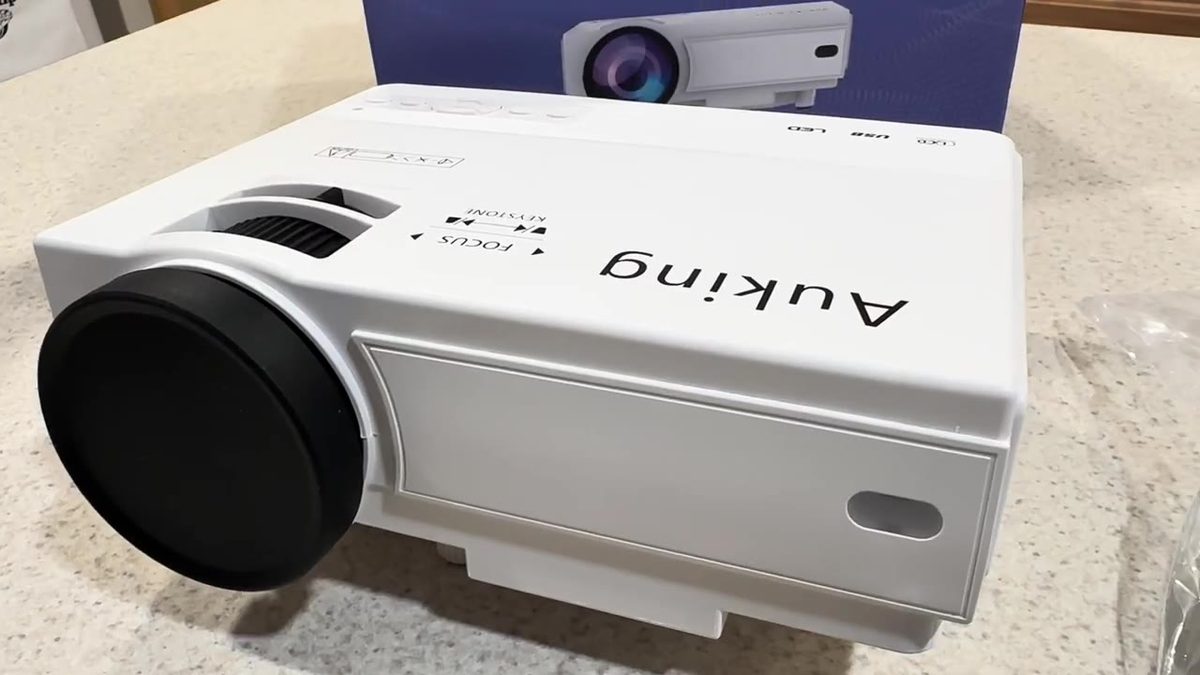 Compact white AuKing home theater projector on the counter
