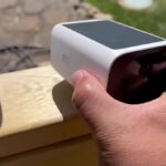 Eufy SoloCam S220 in hand, solar panel on top, eufy SECURITY 2K printed