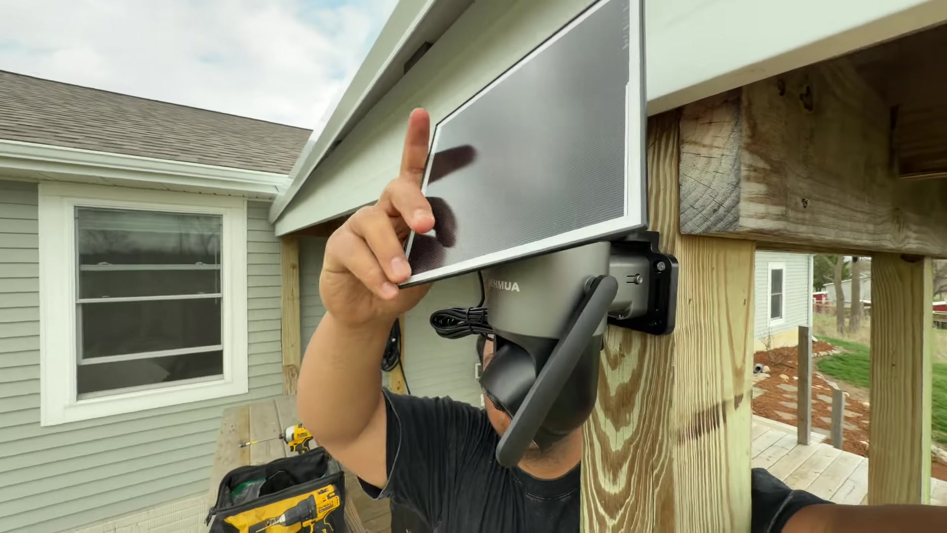 Sliding the solar panel onto the mounted SEHMUA camera