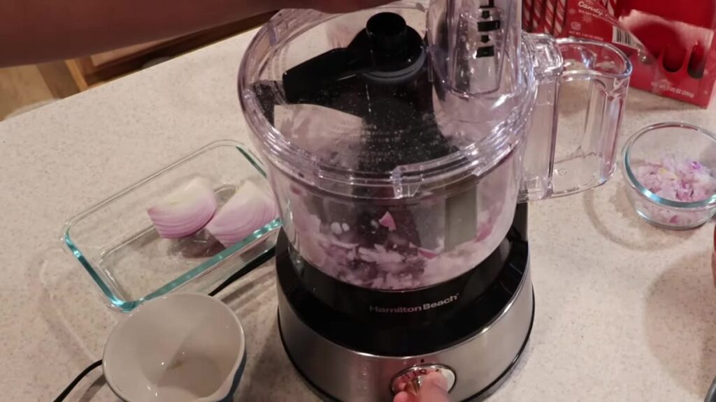 Onion first-pulse in the Hamilton Beach 10-cup, printed brand and lock lever.