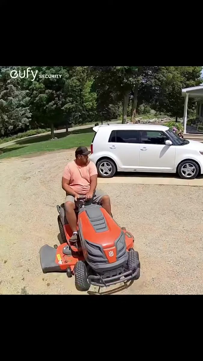 Daytime driveway footage from the Eufy S220, mower and car