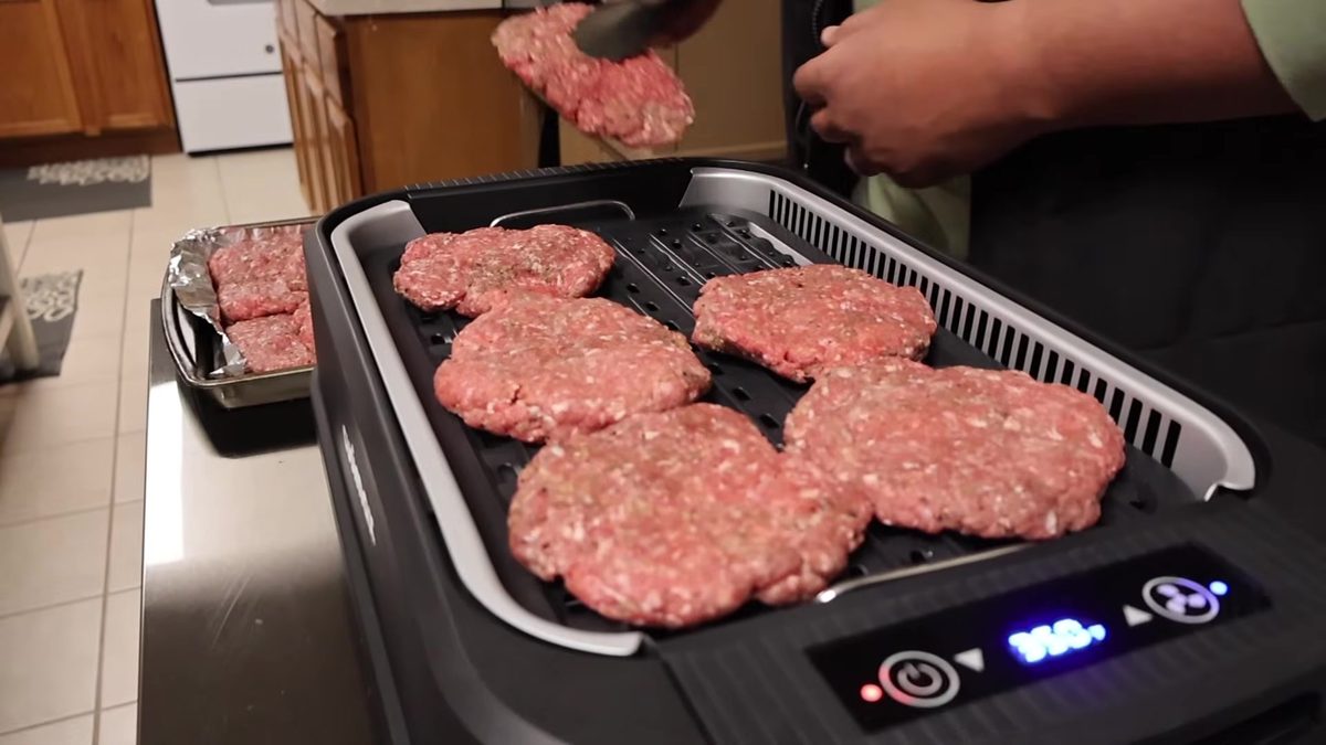 About six quarter-pound patties on the CUSIMAX grill plate