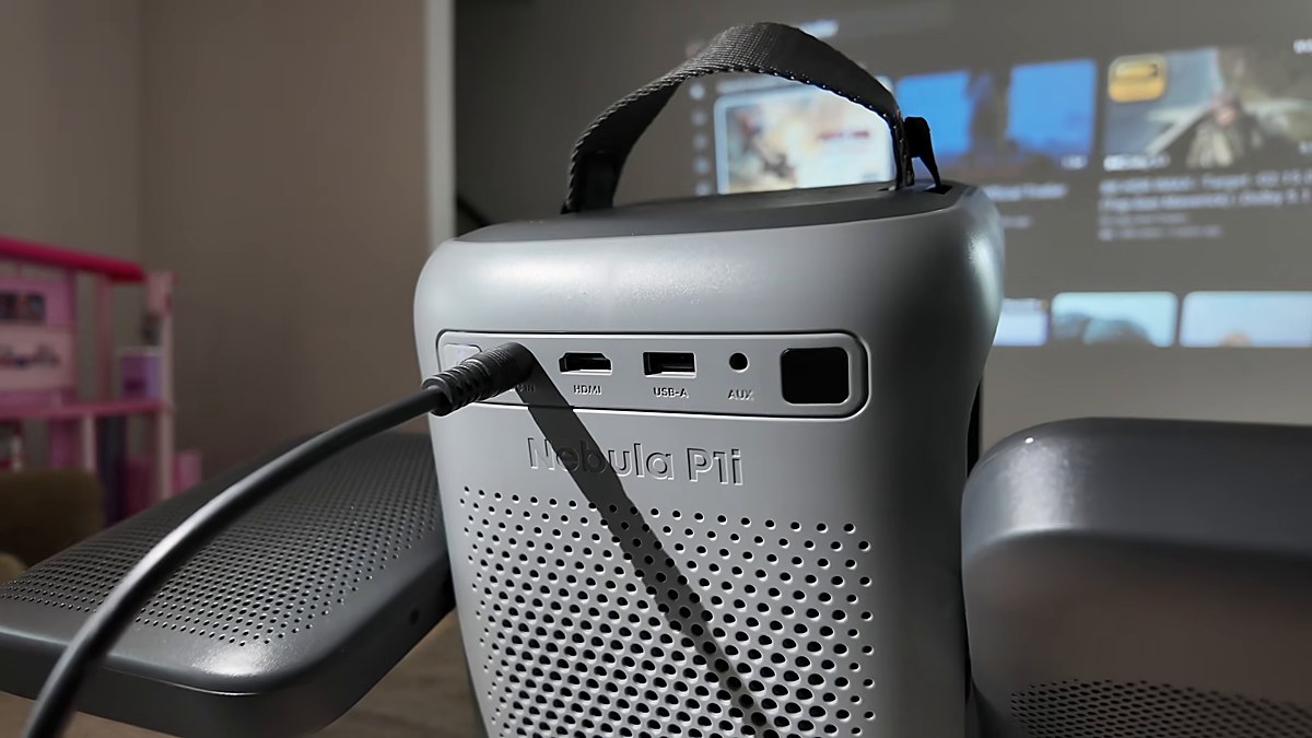 Nebula P1i rear ports with DC-IN power cable plugged in — not wireless