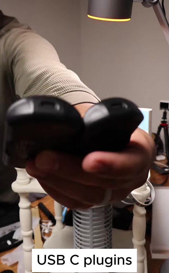 Two black hand warmers held to show USB-C charging ports — USB C plugins in my video
