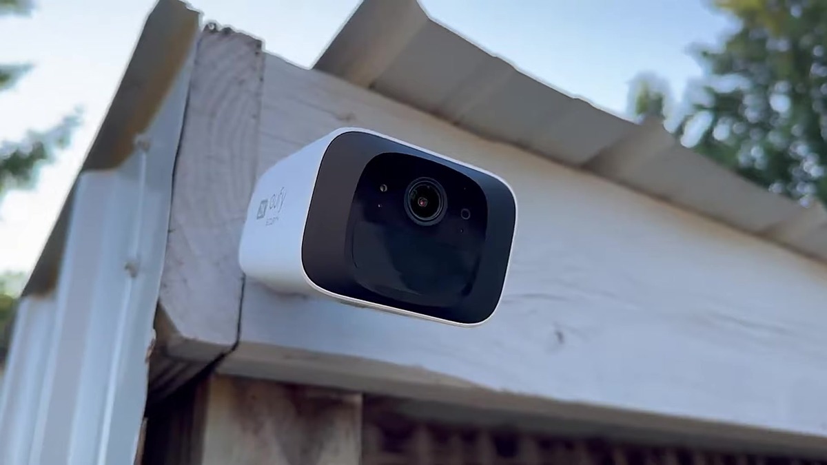 Eufy SoloCam S220 on an outdoor eave, solar panel in sun
