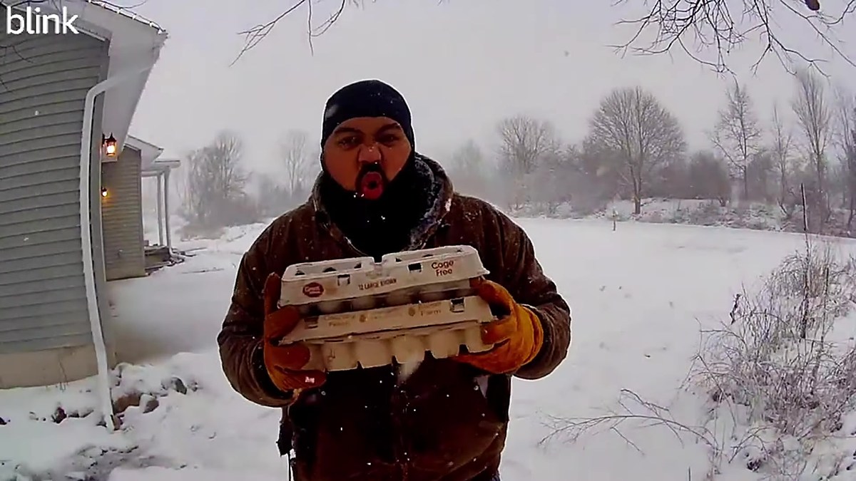 Battery camera house footage in a snowy yard