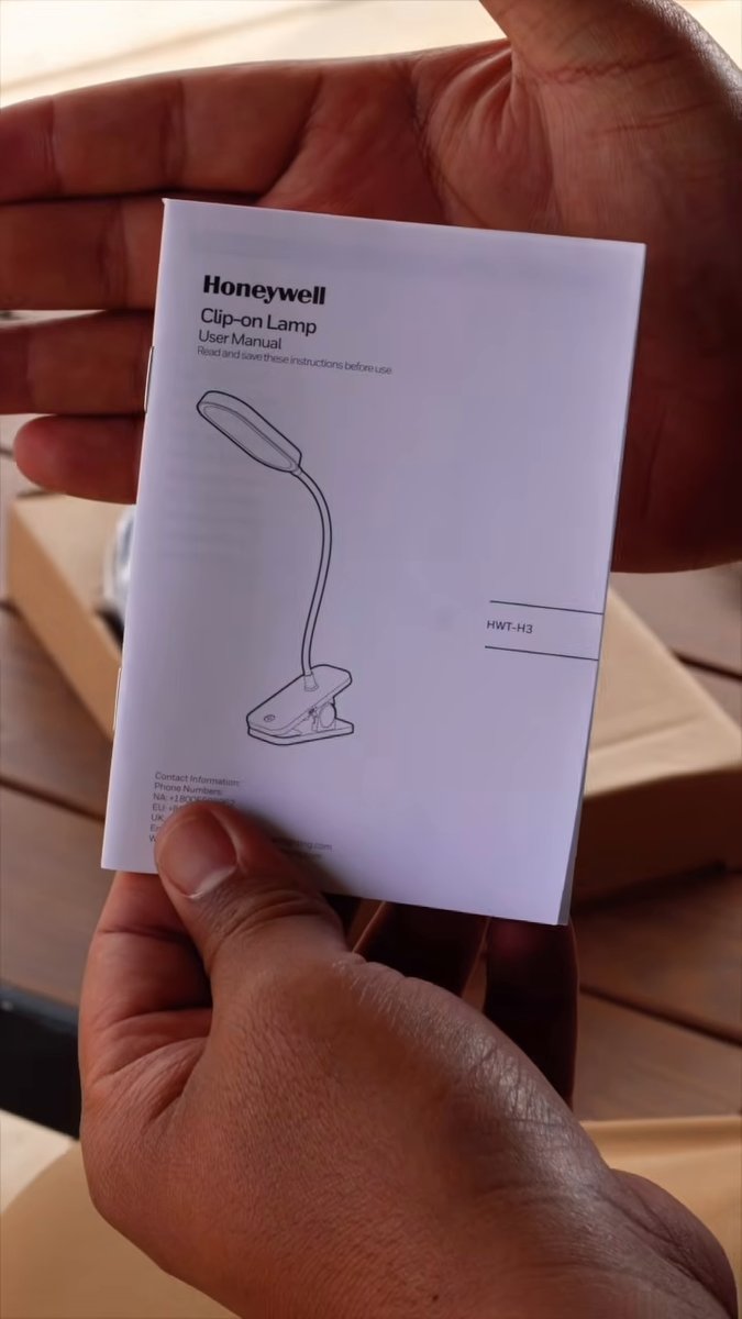 Honeywell Clip-on Lamp HWT-H3 user manual held over the box