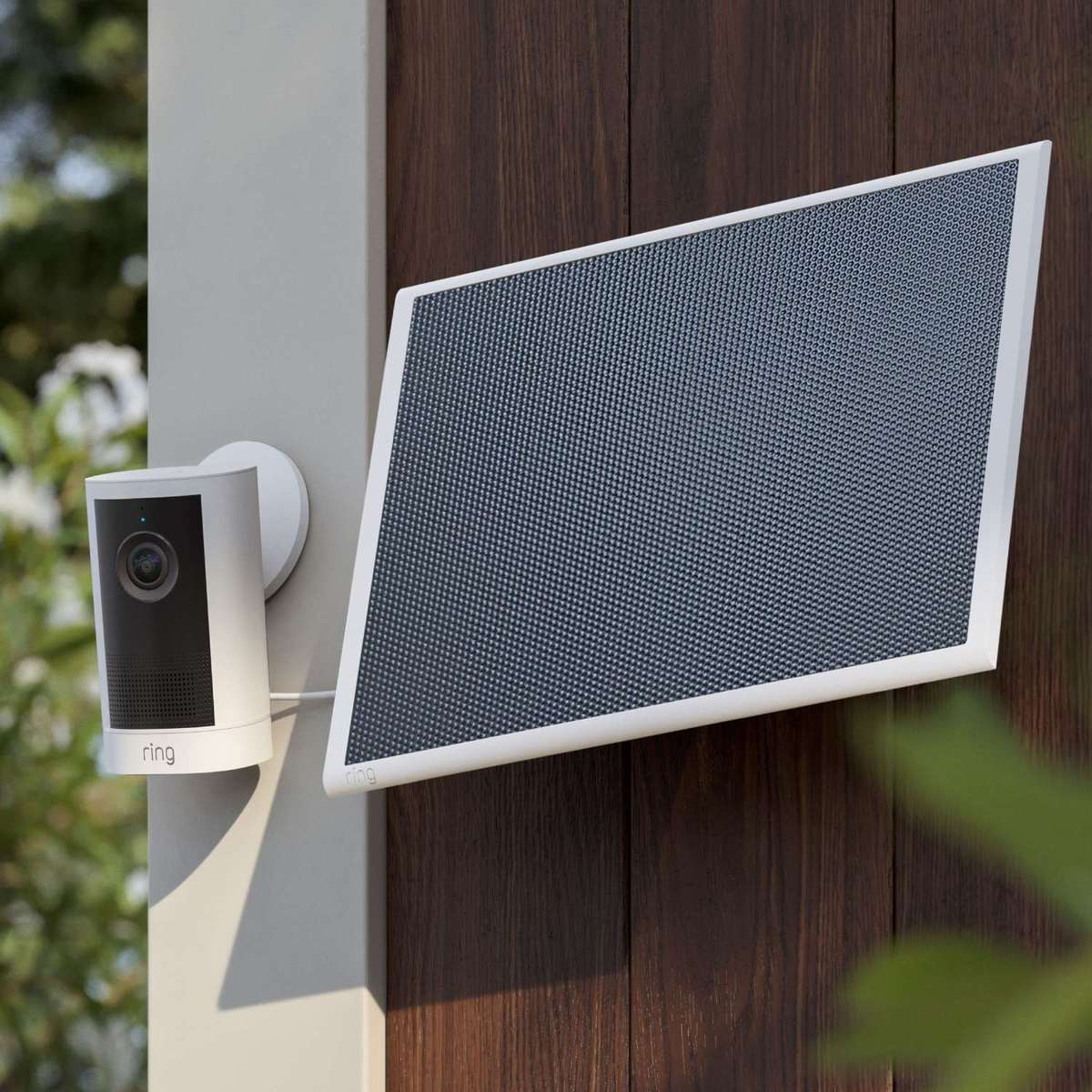 Ring Outdoor Cam 4K Plus mounted on an exterior wall beside its solar panel